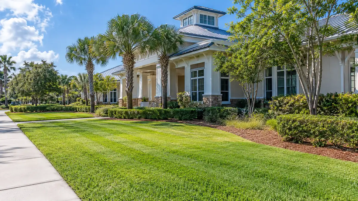 Commercial grounds care Concept rendering: striped lawn and hedges along the walkway of a coastal-style commercial building in Nassau County, FL