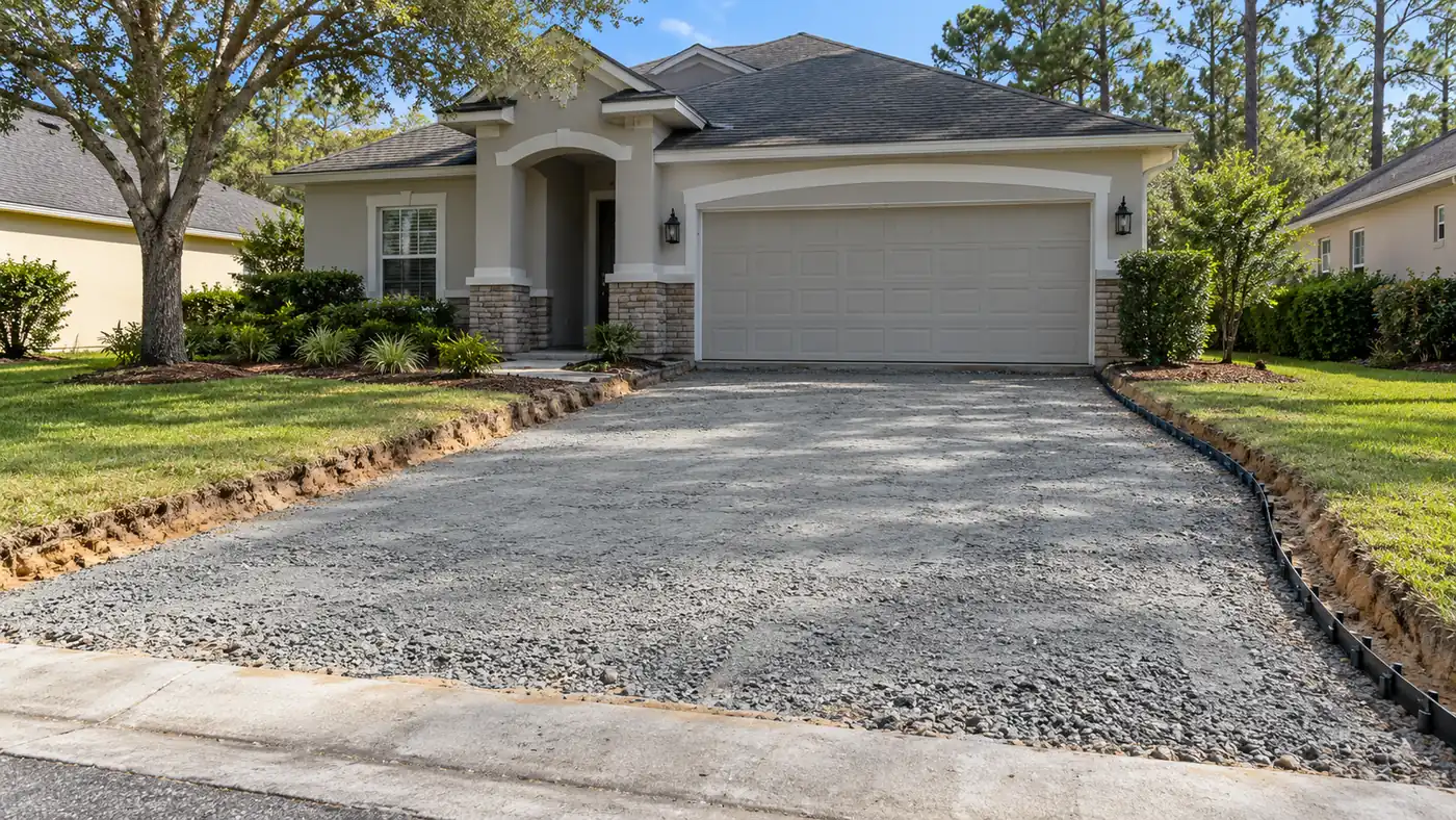 Driveway base prep Concept rendering: excavated driveway with compacted aggregate base ready for pavers at a stucco home in Nassau County, FL