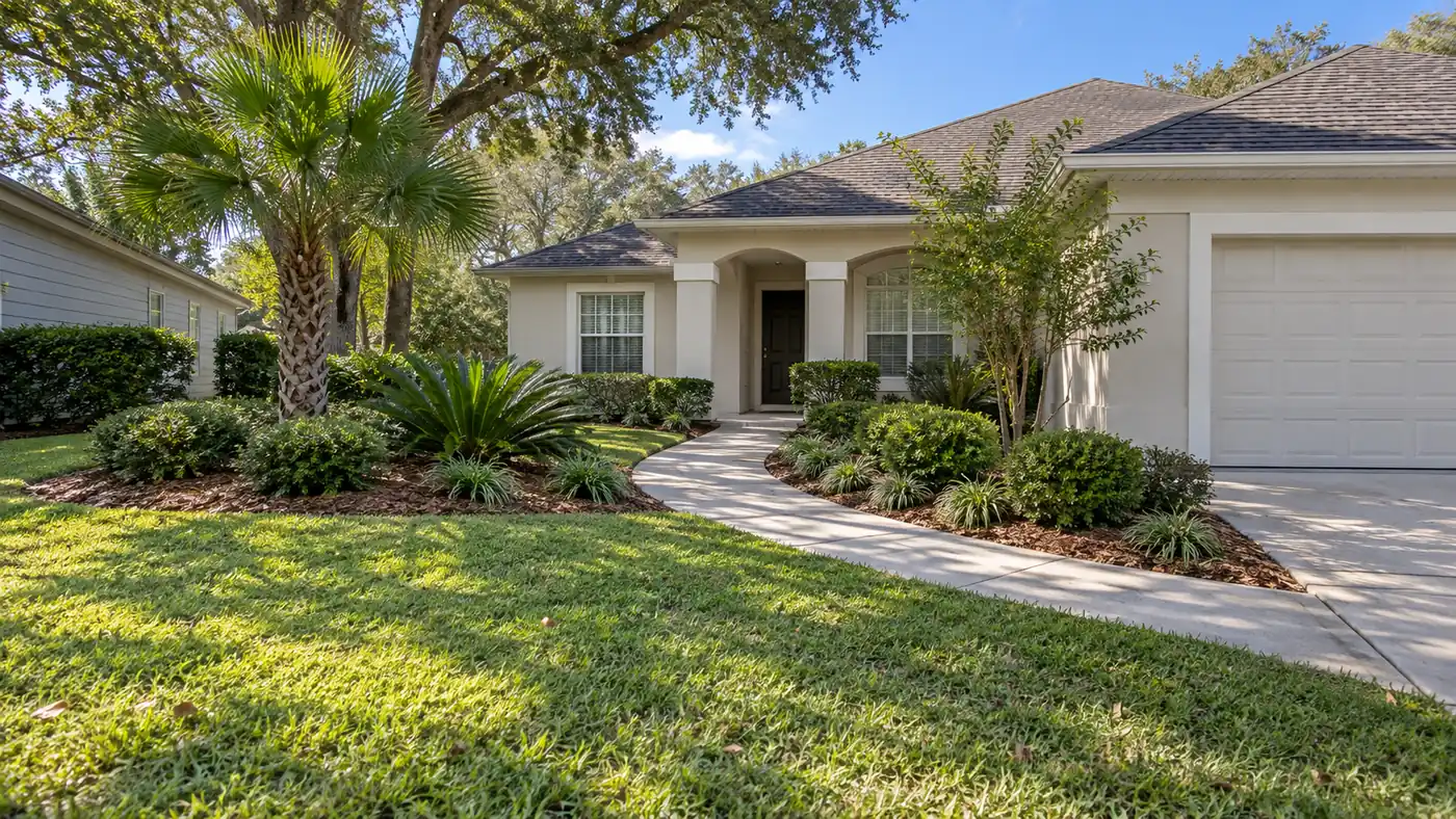 Front yard landscape Concept rendering: front yard landscape with a palm, layered shrubs and a curved walkway at a stucco home in Nassau County, FL