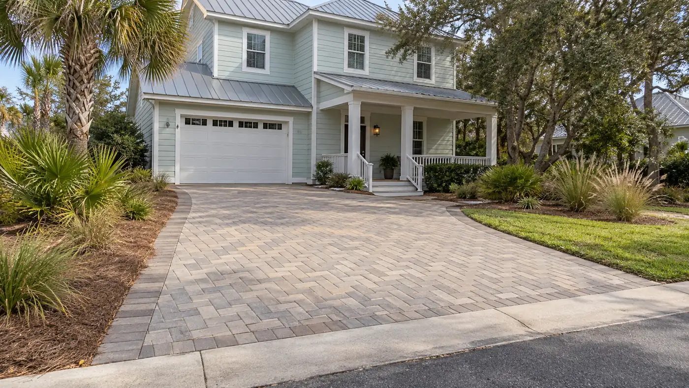 Coastal home driveway Concept rendering: herringbone paver driveway at a coastal two-story home with a metal roof in Nassau County, FL