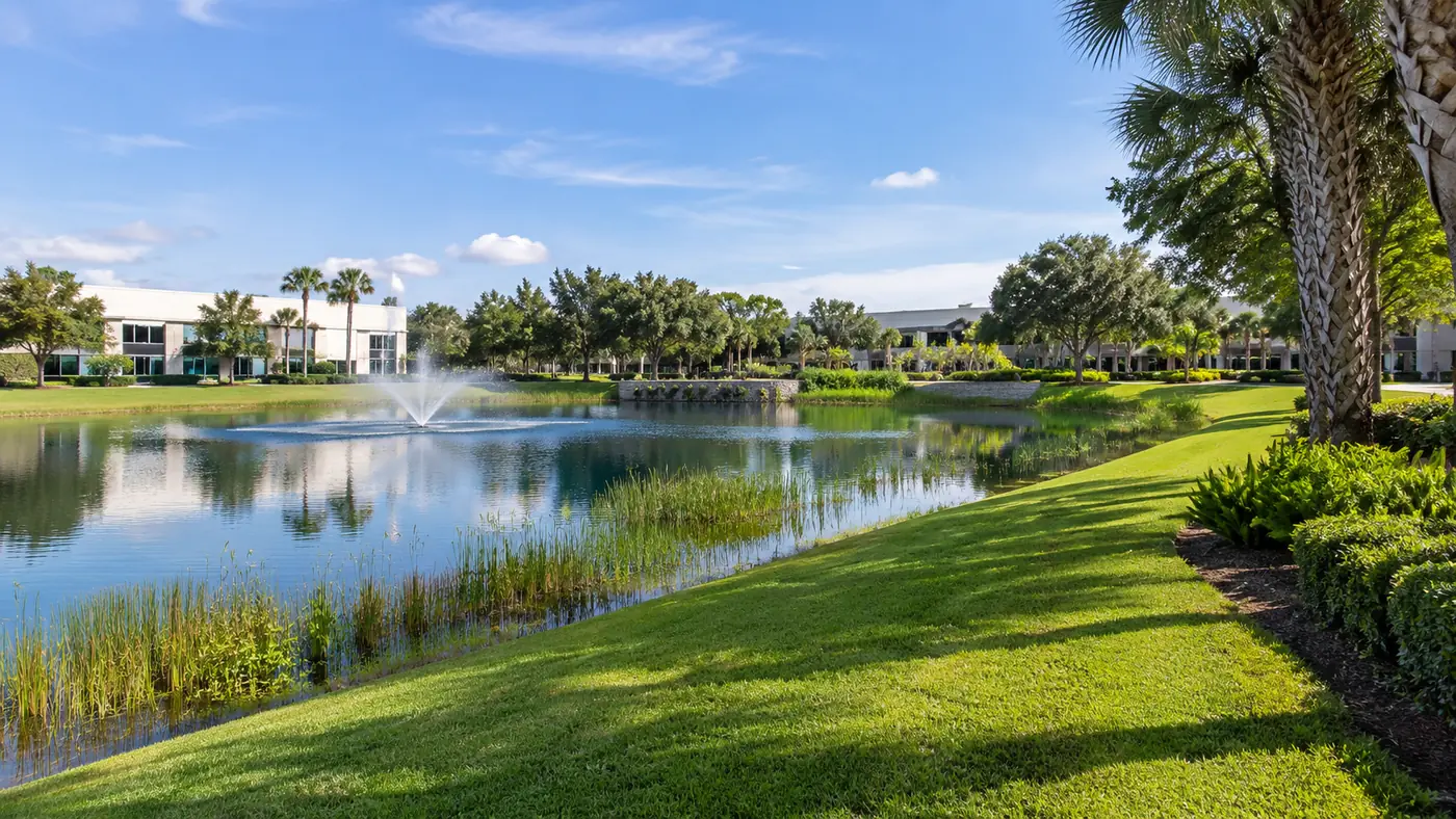 Pond bank mowing Concept rendering: mowed retention pond bank with a fountain at an office park in Nassau County, FL